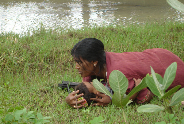 Mother is trying to protect her child from exploding shells